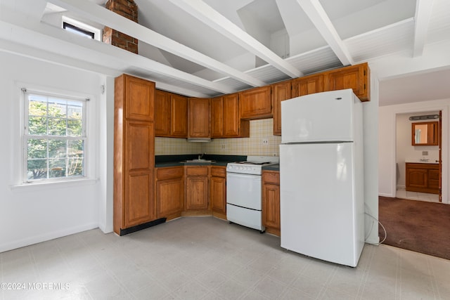 kitchen featuring decorative backsplash, white appliances, beam ceiling, and sink