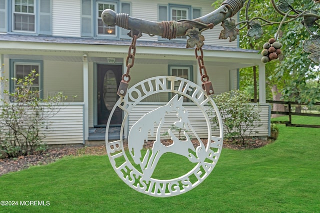 entrance to property with a porch and a lawn