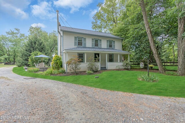 view of front of house with a front yard and a porch