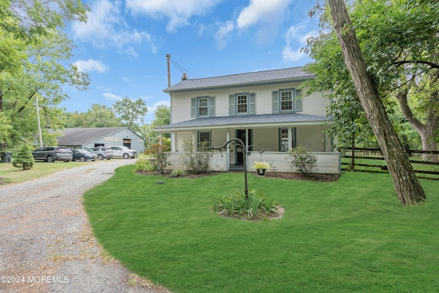 view of front of home with a porch and a front lawn