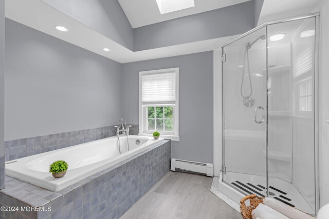 bathroom with a baseboard heating unit, a skylight, independent shower and bath, and wood-type flooring