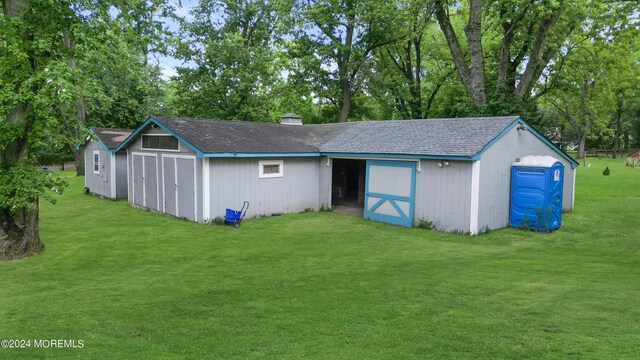 exterior space featuring a storage shed and a lawn