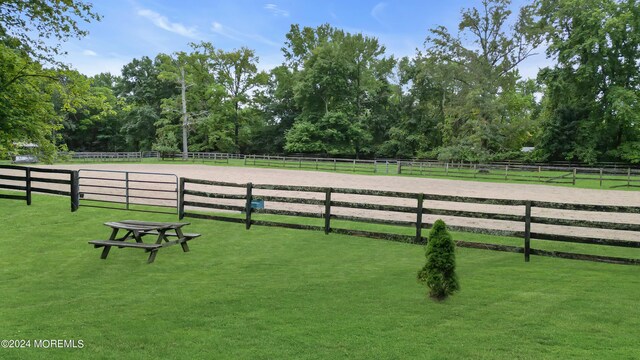 view of property's community with a lawn and a rural view