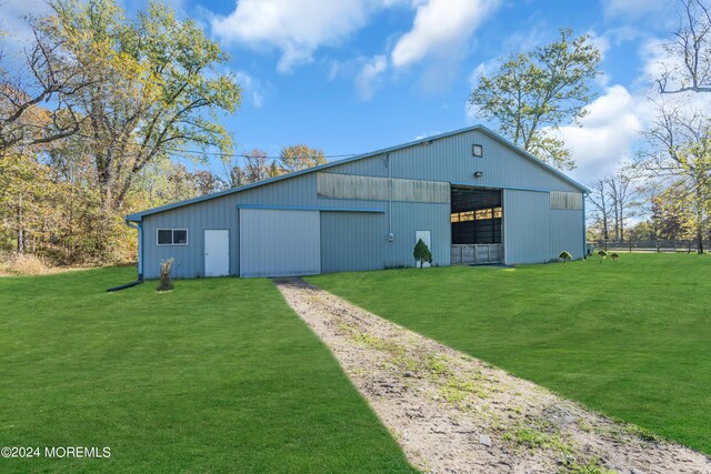 view of outbuilding with a lawn