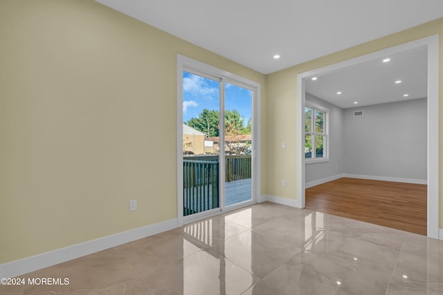 spare room with light hardwood / wood-style floors