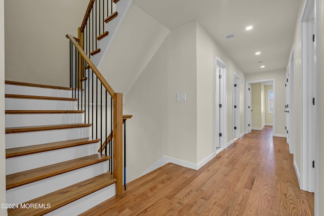 stairs featuring wood-type flooring