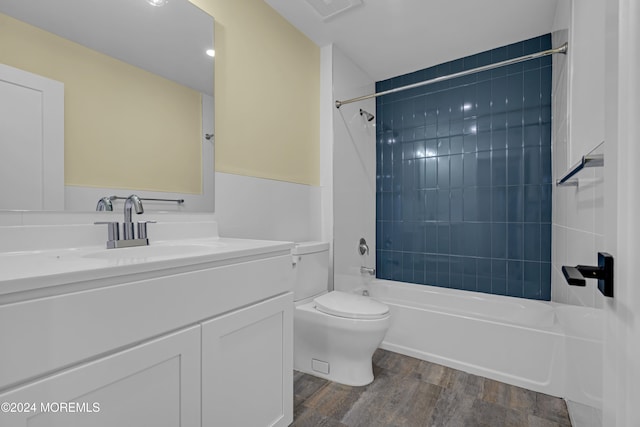 full bathroom with vanity, toilet, hardwood / wood-style floors, and tiled shower / bath