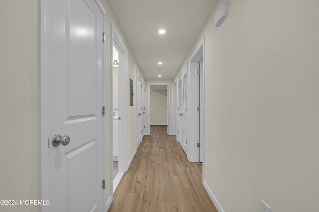 corridor with light hardwood / wood-style flooring