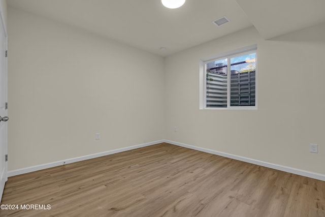 spare room featuring light wood-type flooring