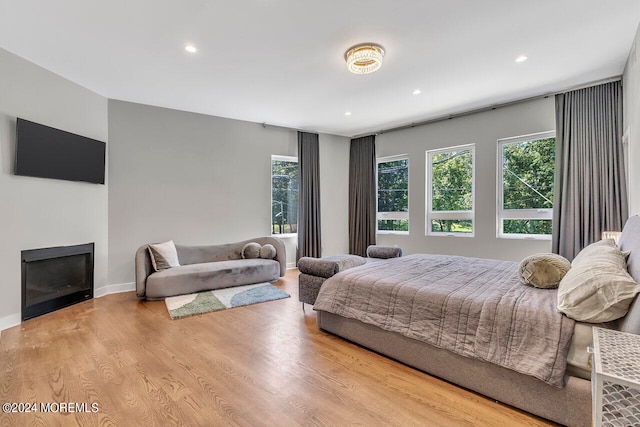 bedroom with light wood-type flooring and multiple windows