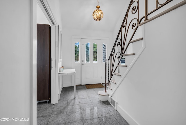 entryway featuring a notable chandelier