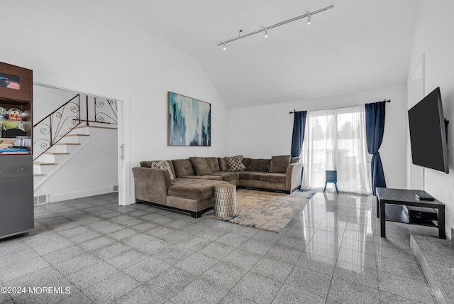 living room featuring high vaulted ceiling and track lighting