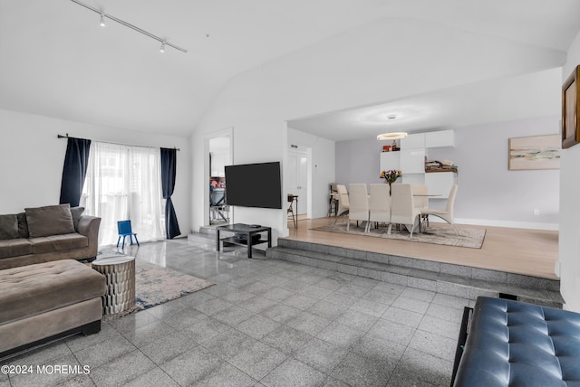 living room featuring lofted ceiling and track lighting