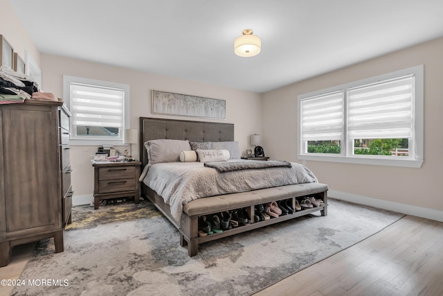 bedroom featuring light hardwood / wood-style flooring and multiple windows