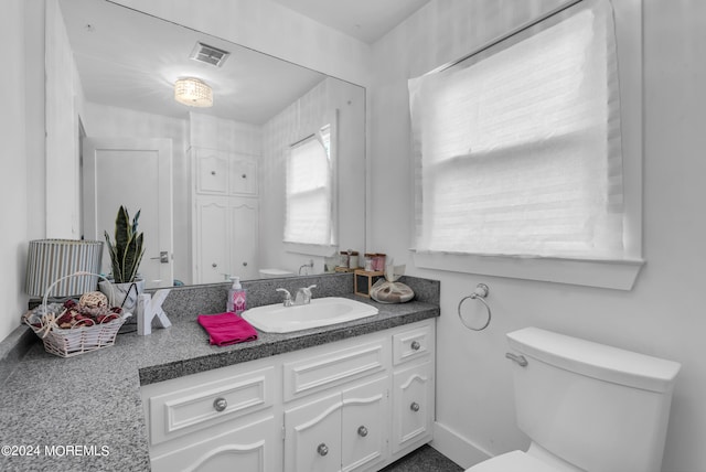 bathroom featuring vanity and toilet