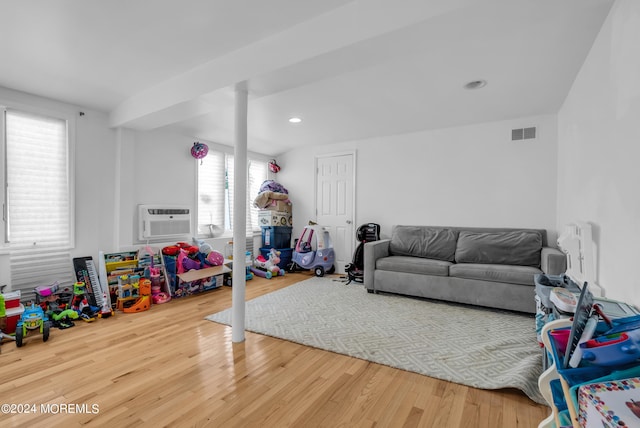 interior space featuring an AC wall unit and hardwood / wood-style floors