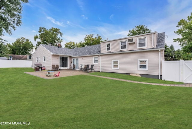 back of house with a yard and a patio area