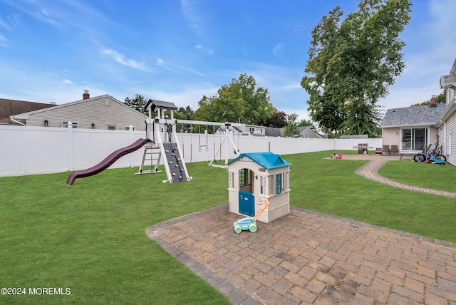 exterior space with a playground and a patio