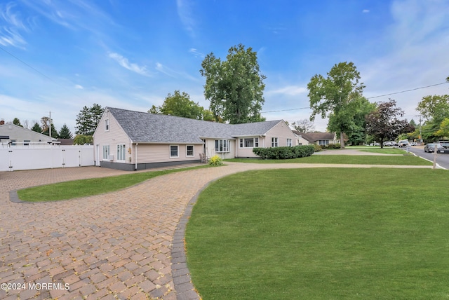 ranch-style home featuring a front yard