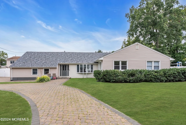 single story home featuring a front yard and a garage