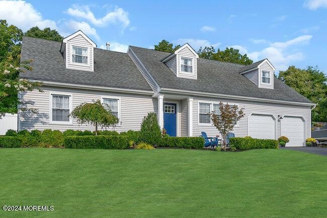 cape cod home with a garage, driveway, a front lawn, and a shingled roof