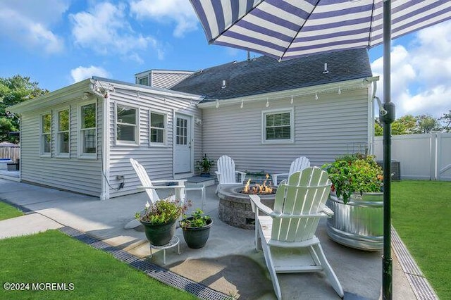 view of patio with an outdoor fire pit, fence, and entry steps