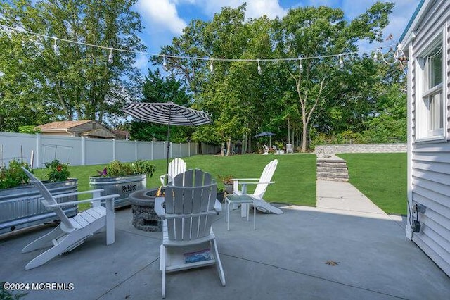 view of patio / terrace with a fire pit and fence