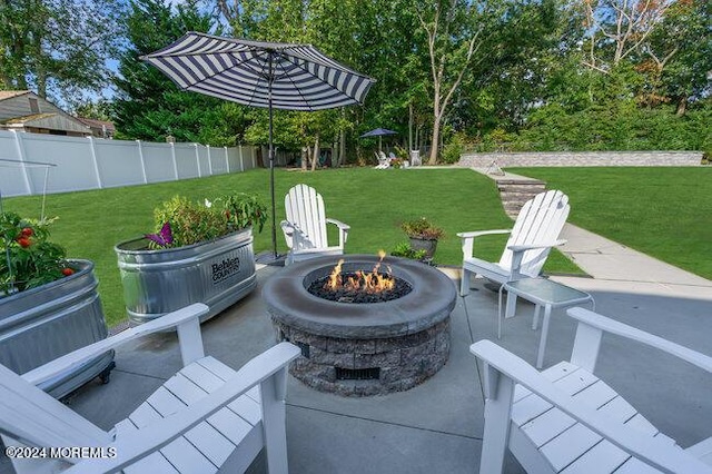 view of patio / terrace with an outdoor fire pit and fence