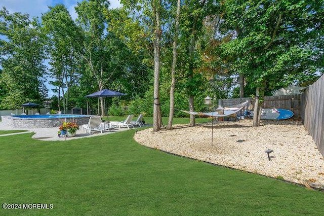 view of yard with a fenced backyard, a fenced in pool, and a patio