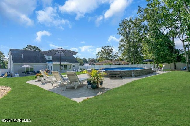 back of house featuring a fenced in pool, a fenced backyard, a lawn, and a patio