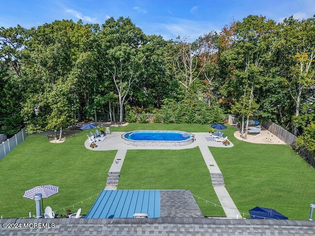 view of pool featuring a fenced in pool, a patio area, a fenced backyard, and a yard