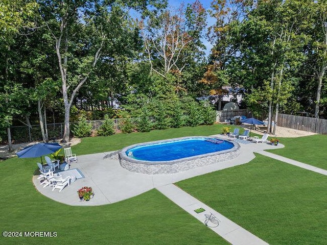 view of pool with a fenced in pool, a patio area, a fenced backyard, and a lawn