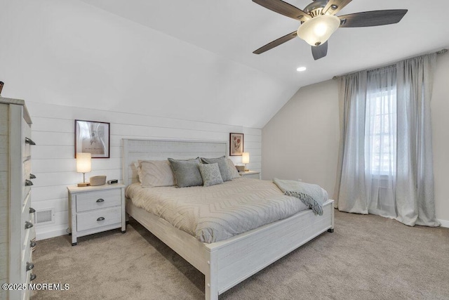 bedroom with light carpet, ceiling fan, visible vents, and vaulted ceiling