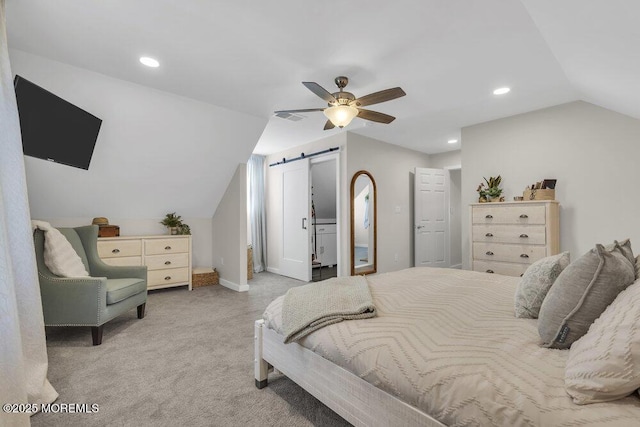 carpeted bedroom with lofted ceiling, a barn door, visible vents, and recessed lighting