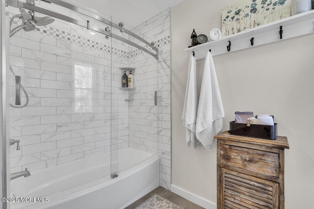 full bath featuring combined bath / shower with glass door and baseboards