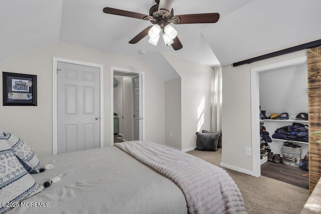 carpeted bedroom with vaulted ceiling, ceiling fan, a closet, and baseboards