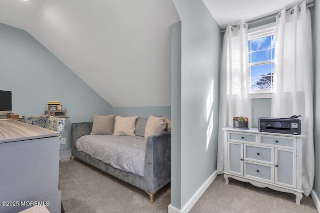 bedroom with lofted ceiling, baseboards, and light colored carpet