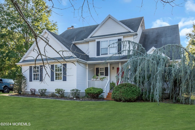 view of front of property with a front yard and a porch