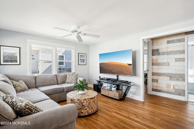 living area with wood finished floors, ceiling fan, and baseboards