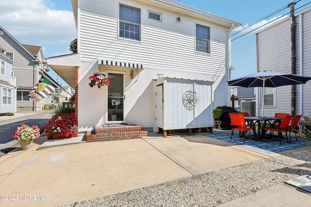 rear view of house featuring a patio area and outdoor dining space