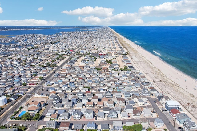 aerial overview of property's location featuring waterfront with a beach