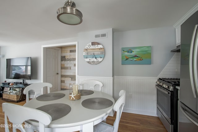 dining area with wainscoting and dark wood-style floors