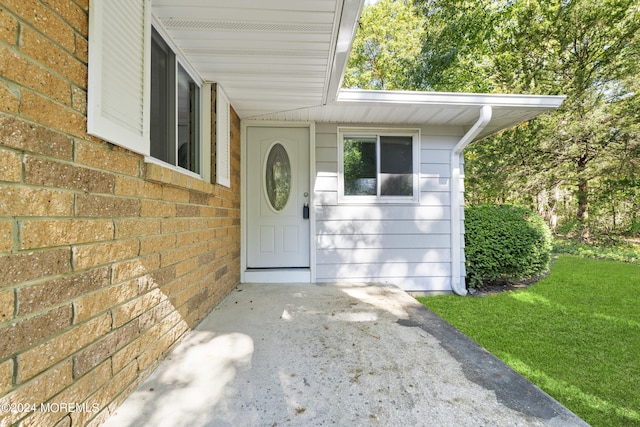 doorway to property featuring a yard