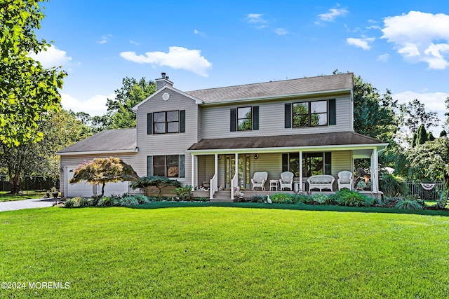 view of front of house with a garage, a front lawn, and covered porch