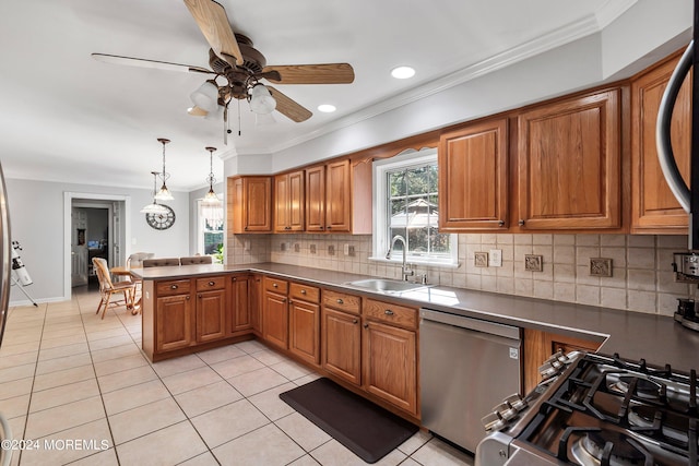 kitchen with ceiling fan, sink, decorative light fixtures, stainless steel appliances, and decorative backsplash