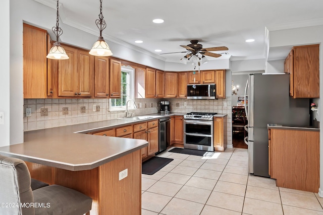 kitchen featuring ceiling fan, pendant lighting, kitchen peninsula, stainless steel appliances, and crown molding