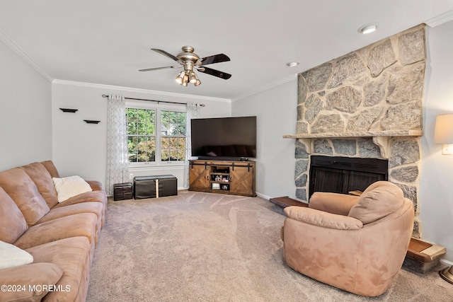 carpeted living room featuring ornamental molding, ceiling fan, and a stone fireplace