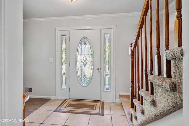 tiled foyer featuring crown molding