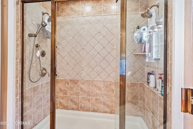 bathroom with a shower with door