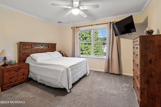 carpeted bedroom with ornamental molding and ceiling fan